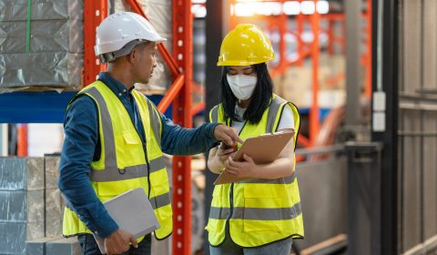 Working at warehouse. Male warehouse worker checking in storage department. Employee organizing goods distribution to the market
